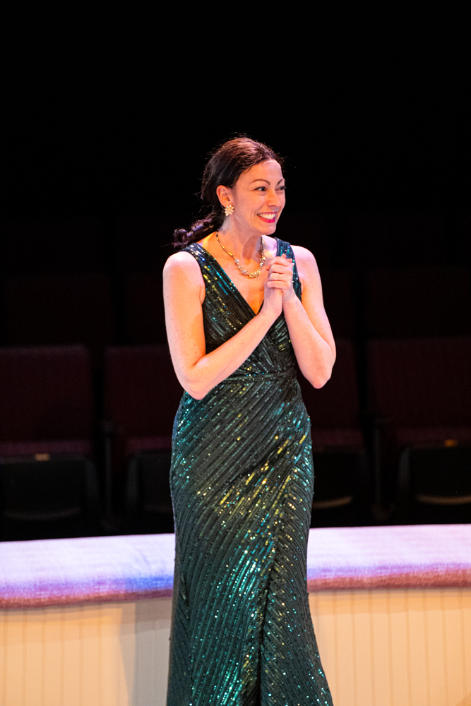 Woman in a green sparkly ball gown with happy expression at Irish Classical Theatre Company